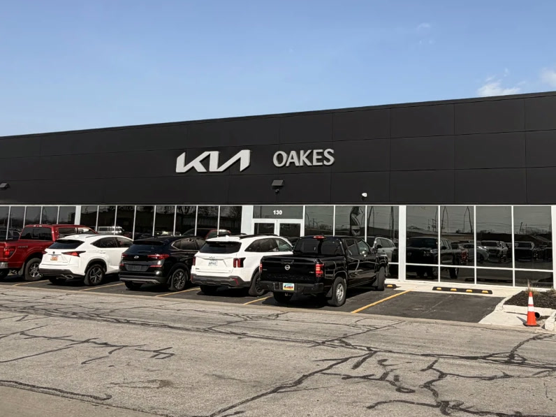The Oakes Kia of Olathe showroom, with the new Kia logo, in Olathe, KS